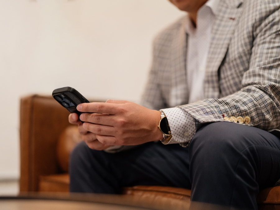 Aaron Yoon, CFP sits in his office in Seattle, returning a client's text.